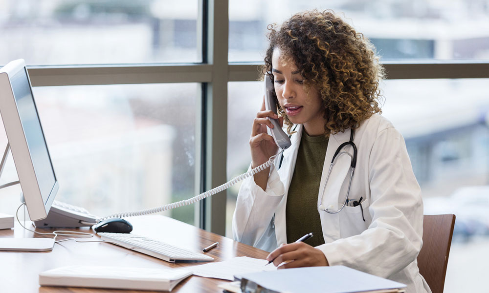 Doctor on call with patient