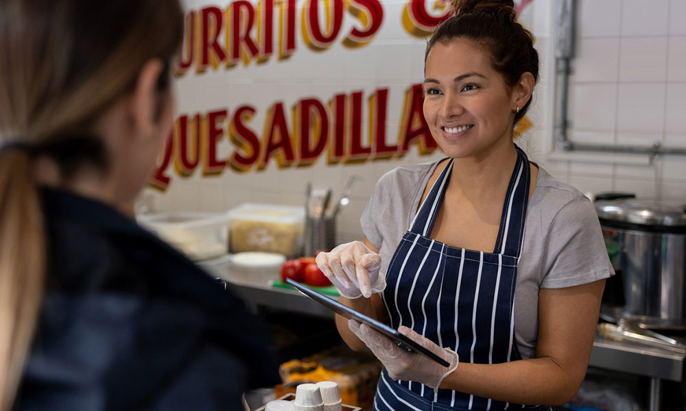 Cashier taking an order on a tablet