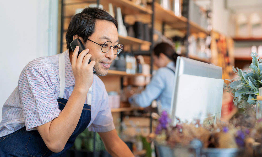 Store owner on phone with a customer