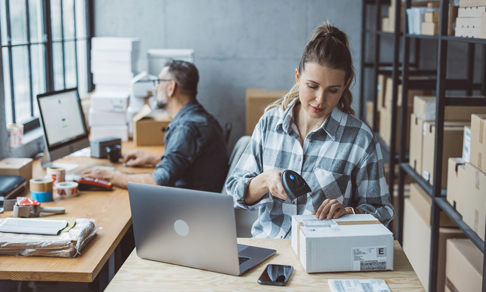 Small business owners preparing online orders